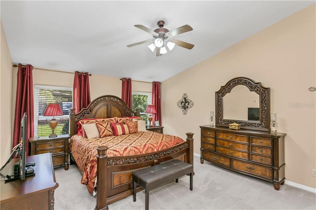 Huge Master Bedroom easily accommodates king-sized bed and matching furniture. Backyard in window view.