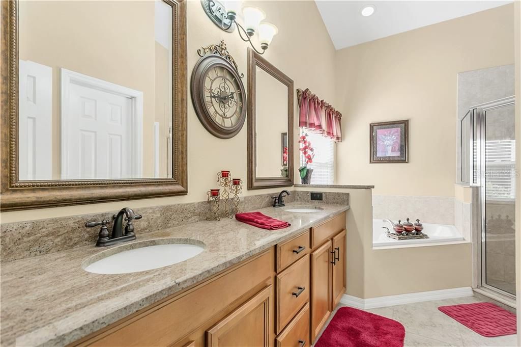 Master Bathroom with updated granite and mirrors. Not seen, large walk-in closet and water closet with door.