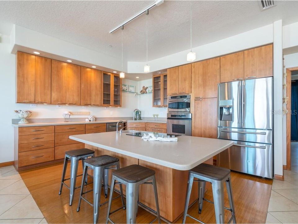 The kitchen is well equipped with stainless steel appliances, bamboo flooring and a nice size center island.