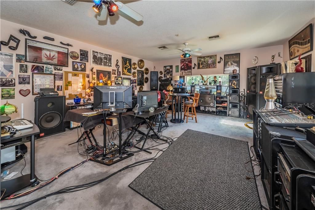 BONUS ROOM, PRESENTLY USED AS A MUSIC STUDIO COULD BE GUEST SUITE, HOME OR PROFESSIONAL OFFICE, PLAYROOM, GAME ROOM ETC. IT ALSO HAS A DOOR THAT LEADS TO FRONT OF HOUSE ENTRANCE WAY SIDEWALK.