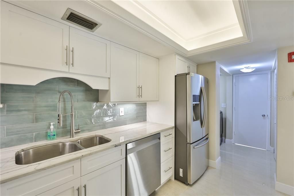 Quartz countertops and custom tile backsplash. Convenient laundry ( full size washer&dryer) is located off the kitchen