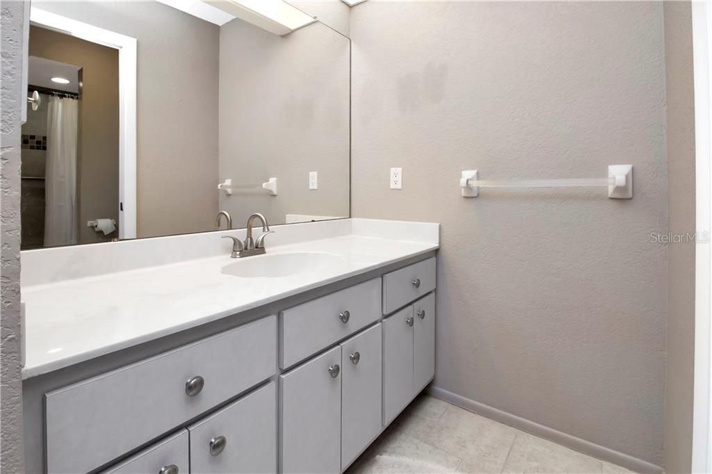 Master bathroom with single sink and walk in shower