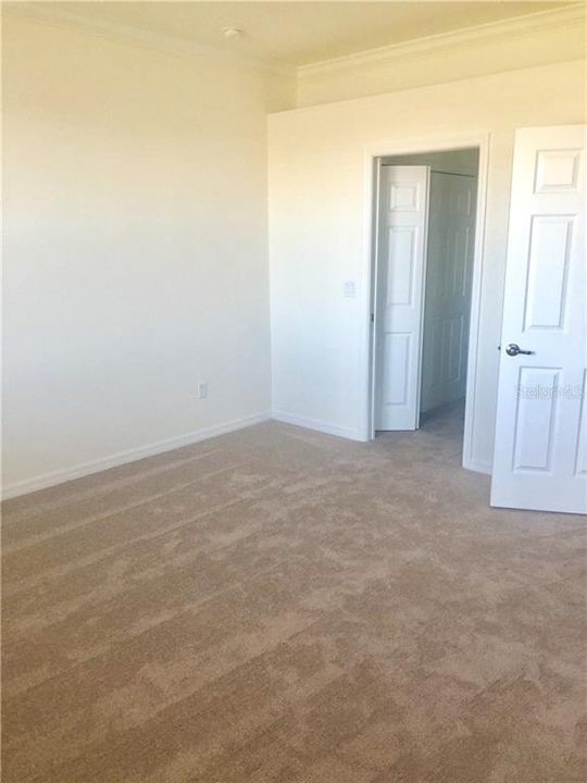 Master Bedroom with hallway to bath and two closets.