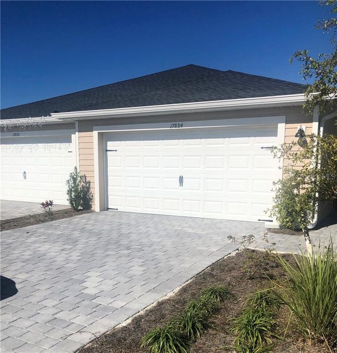 Front of villa with decorative pavers.