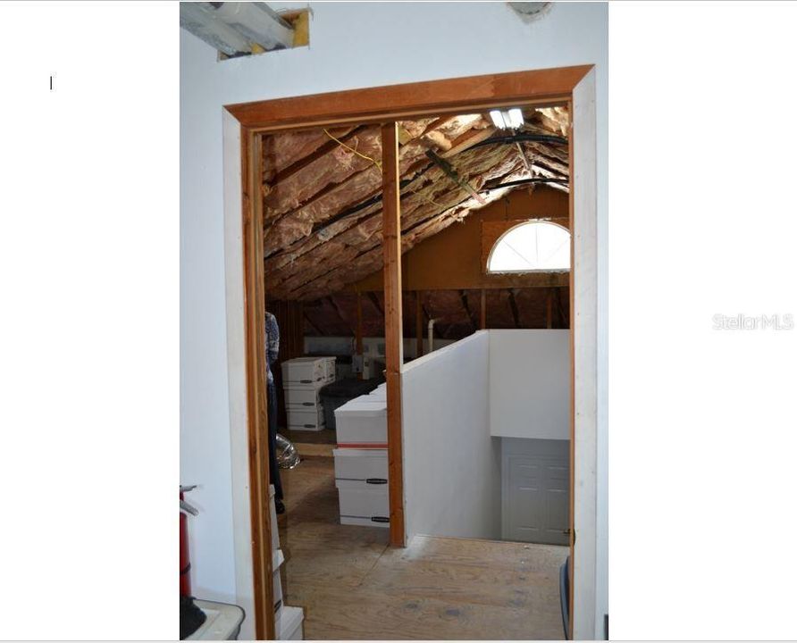 Additional storage spaces on each side of stairwell in the attic.