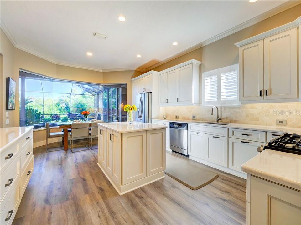 What a gorgeous kitchen.  New gas range. Stainless appliances, storage for everything and eat in dining area with aquarium glass overlooking the patio, pool and lake