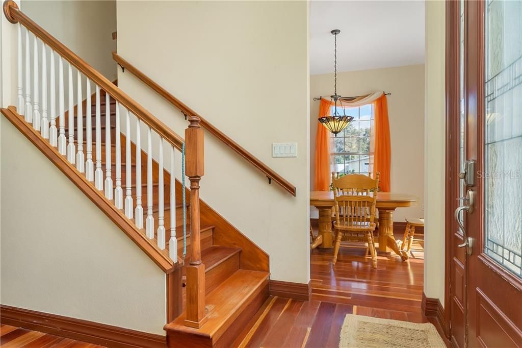 Beautiful Staircase at entrance. Dining Room straight ahead. All with Brazilian cherry flooring and extra nice wood trim.