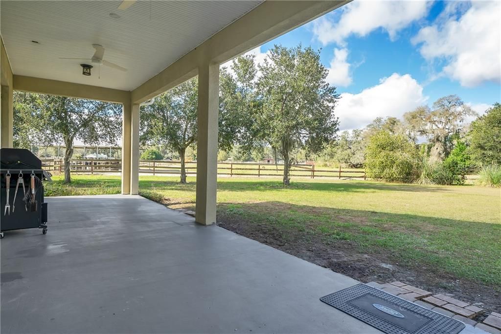 Rear porch looking towards one of the paddocks.  Perfect to watch the horses and enjoy some back yard time.