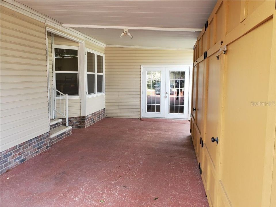 room. has storage on right, golf cart garage with French doors straight ahead and front door on left.