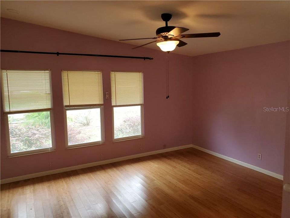 Bright master bedroom has hardw2ood floor and remote controlled fan/light.  Cathedral ceiling adds to spacious feeling in this large room.