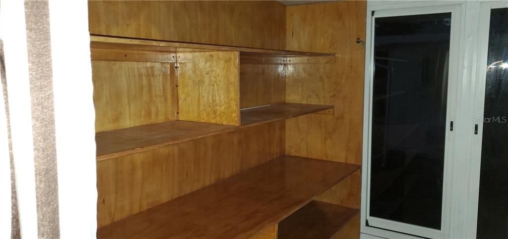 Storage shelves and counter top in laundry room, great for folding cloths.