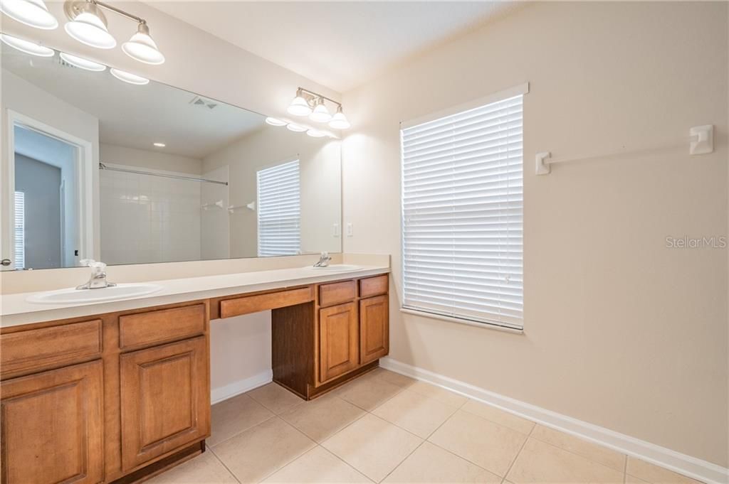 Master Bathroom features dual sinks, tub/shower combo, private toilet room & plenty of cabinetry for storage.