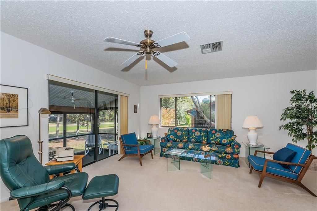 Living Room Into Enclosed Patio with Golf Course Views