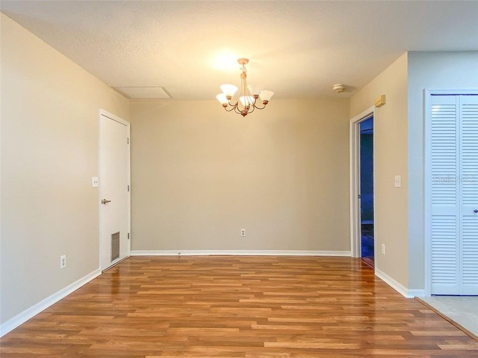 Dining area, door to garage, and entrance to master bedroom