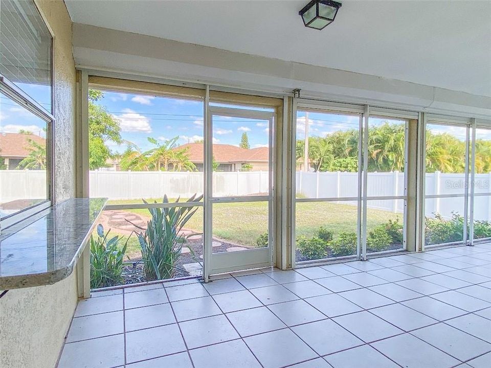 Screened lanai with roll down shutters- nice large area to entertain, outdoor dining. The pass through window makes it easy!