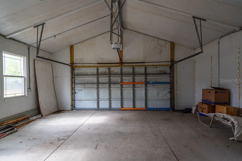 This garage includes volume ceilings and an electric door opener.