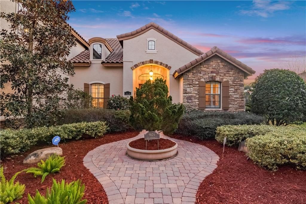 Lovely professionally landscaped entry gives way to the double leaded glass front doors & foyer.