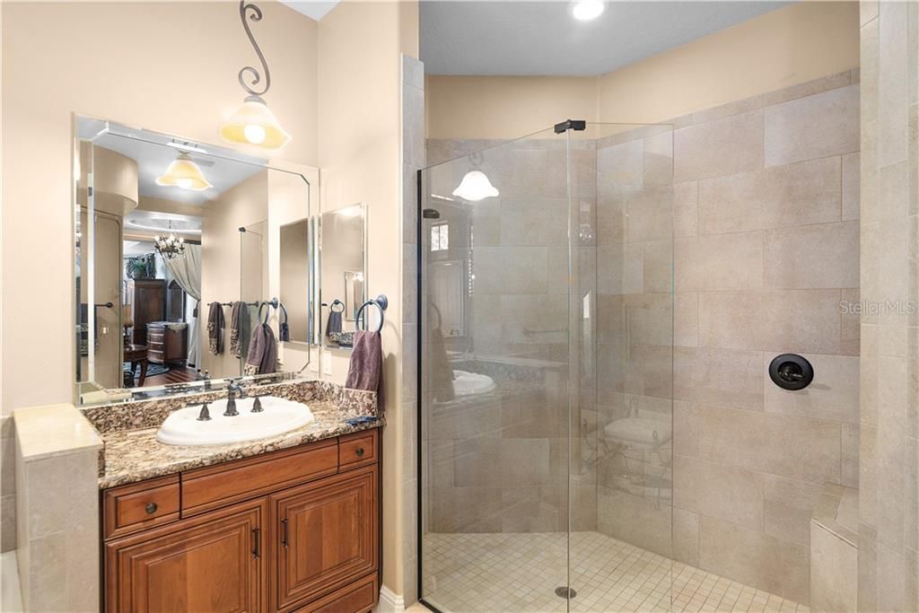 Spacious glassed shower with built in seating.