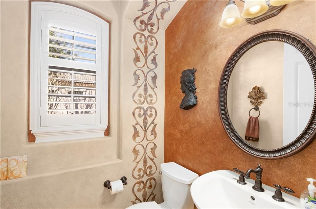 This powder room will delight your guests with the exquisite faux painted walls and decor.