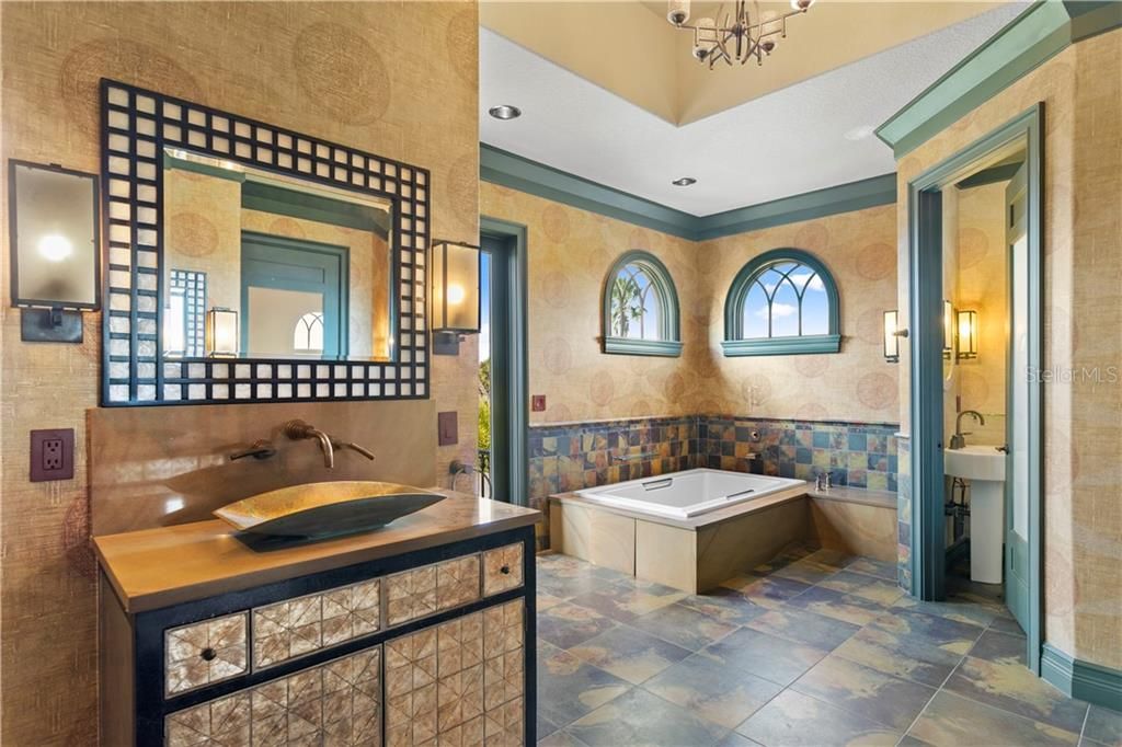 The first master bath has a bath tub in addition to the walk in shower, a separate room which has a sink, commode and bidet
