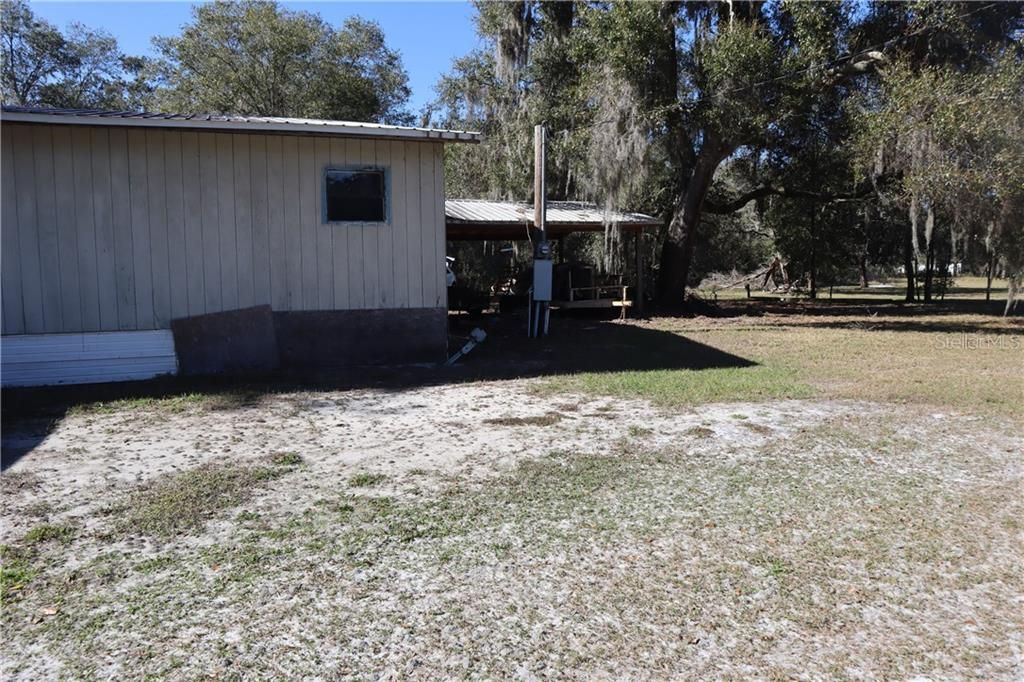 Side of home, view of the carport.