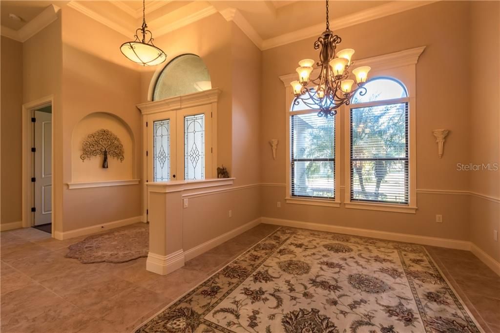 Formal Dining Room,  Step up Ceiling with uplighting, Tile Floors, 8" Crown Molding, 6" Baseboard, Cornice Molding around Doors and Windows and Decorative Niche with Arch.