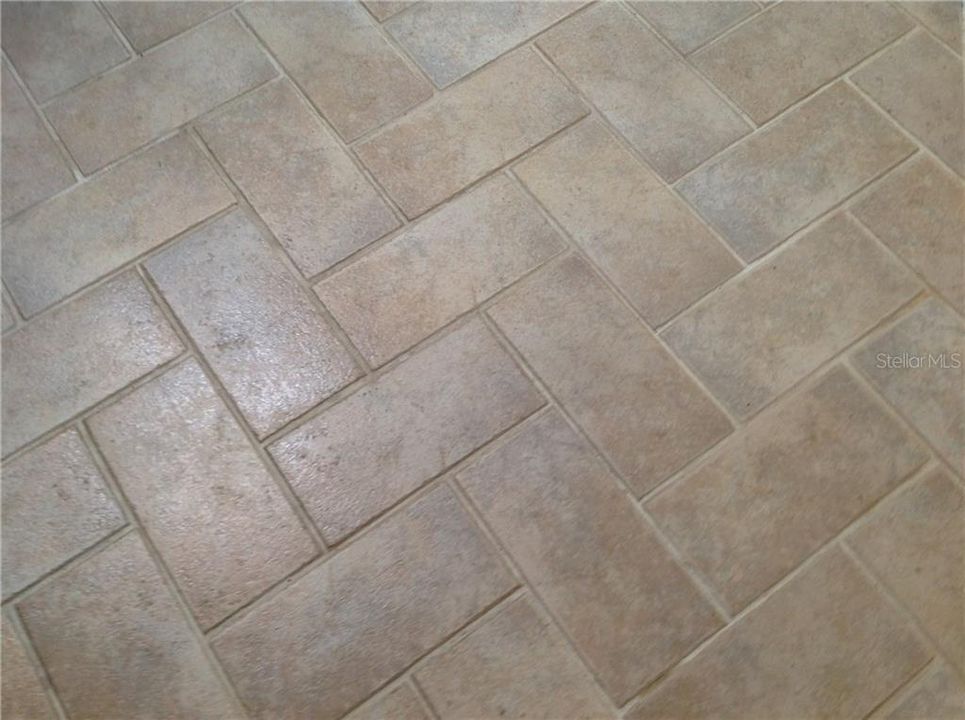 Herringbone tile in living room, dining room and kitchen