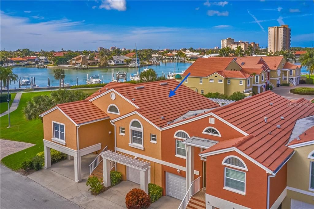 Spectacular views of Boca Ciega Bay and Marina Bay's private marina located on an extra-wide channel (over 400') on the southern tip of Pinellas County - an unparalleled boating location!  Front elevation photo of 34 Franklin shows first level garage and carport (on the left), with all living space on the second level.