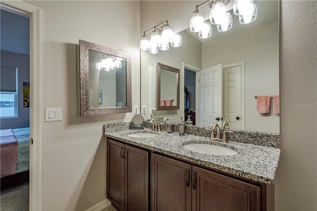 Granite counters and deep mirrored medicine cabinet