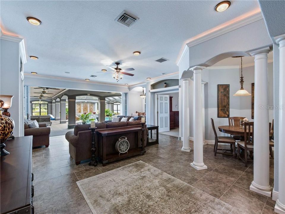 The Great room completely opens up to the outside covered lanai area. You can see the Breakfast Nook to the right surrounded by beautiful columns.