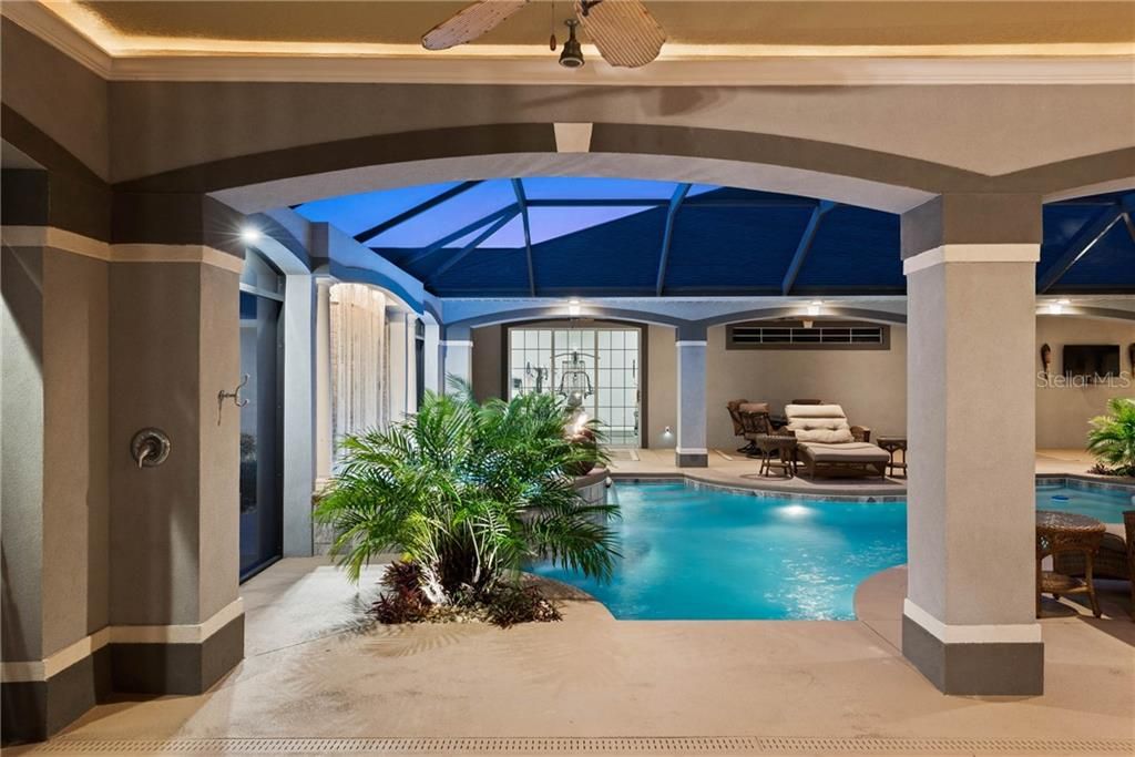 Notice the water fountain spilling into the heated spa and the Outside shower with a rain shower head.