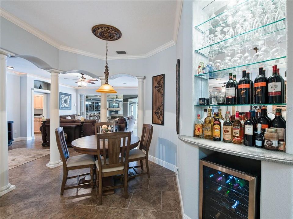 Love the very spacious 9' x 8' Breakfast Nook surrounded by columns, nestled off of the Kitchen, Family and Living rooms with a built-in Butler Bar with the wine cooler, glass shelving and a radius DuPont Corian Countertop.