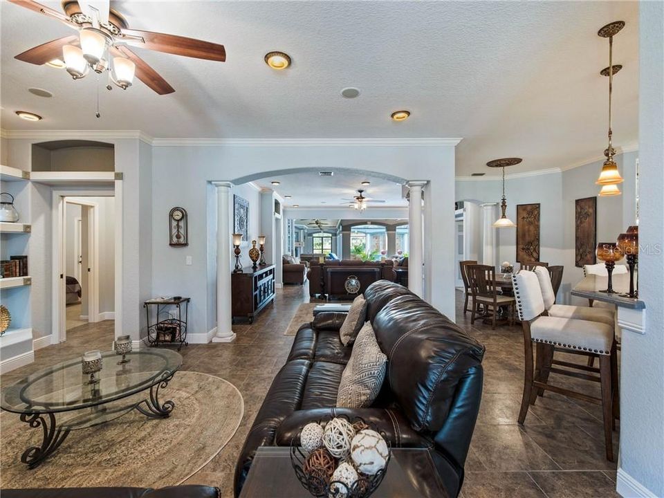 Great view of your own Tropical Pool Oasis right from your Family room and open to the Living Room, Kitchen, and Breakfast Nook. The door you see to the left is a pocket door to the Guest Bedroom En Suite.