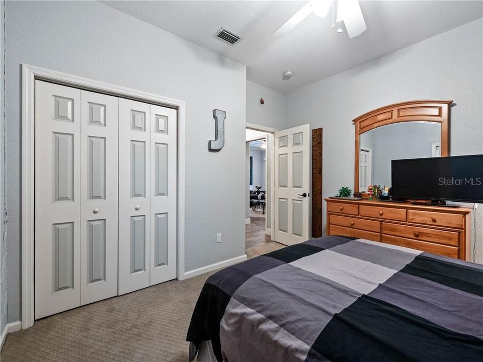Private 3rd Guest Bedroom En-Suite with pocket door closing off space from Family Room for Guest privacy.