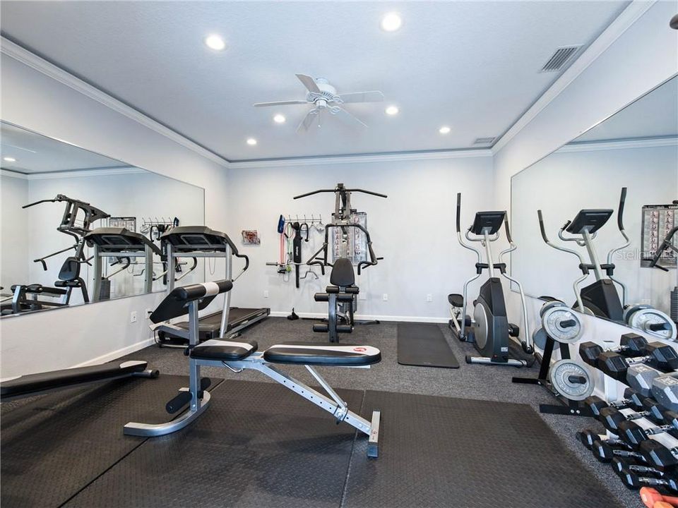 No gym Membership required! This "Turn Key" personal Home Gym includes the equipment and mats!Finished with mirrors, Crown molding with ambient rope and recess lighting, TV mount, high density commercial grade carpeting and multiple phone and cable jacks! AND....a 220 Volt pre-wire for your tanning bed!