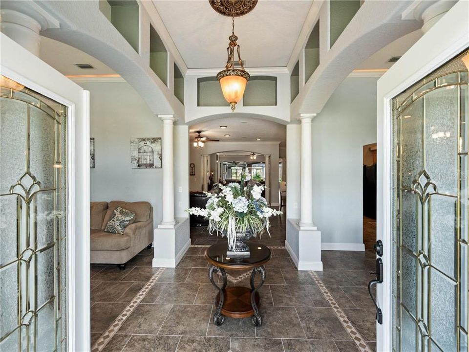 Enter into the welcoming foyer through the double leaded glass entry doors with the Formal Living Room on your left and Formal Dining Room on your right and the Family and Great Room will be straight ahead. Notice the amount of detail from the moment your enter into this open and spacious, split bedroom home.