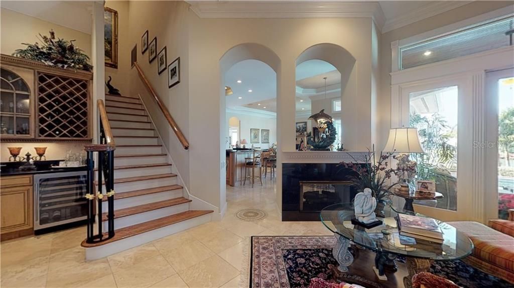 Double sided Gas fireplace separating formal Dining and living area,  from more casual Kitchen, Breakfast nook  and Great Room area.