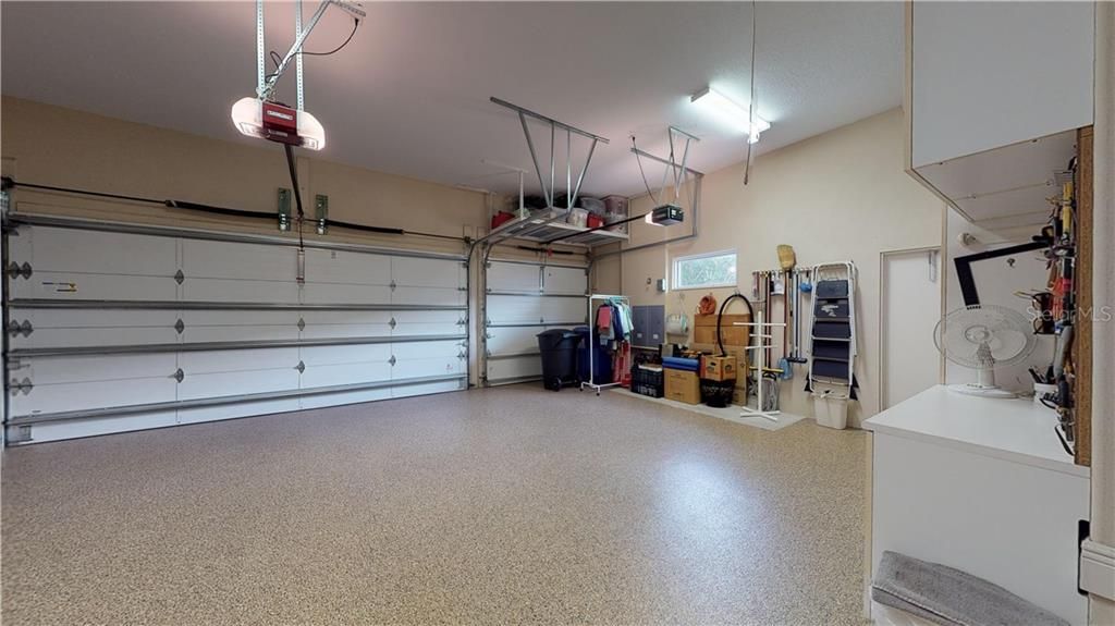 Large 3-car garage, with top quality flooring, overhead storage shelving and custom California Closets cabinets! plenty of storage.