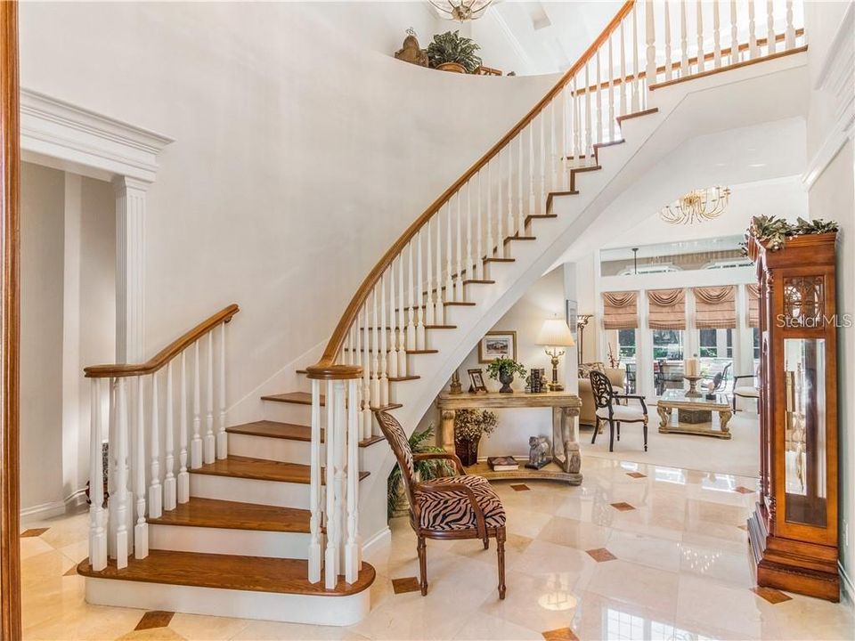 TWO STORY ENTRY WITH IMPRESSIVE SWEEPING STAIRCASE