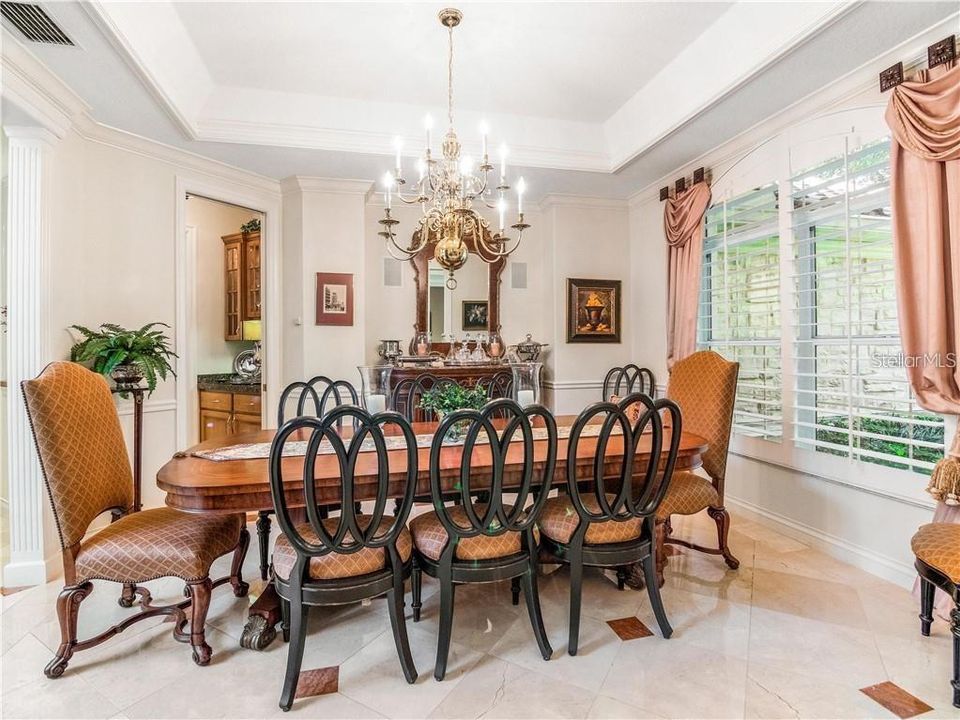 SPACIOUS FORMAL DINING ROOM HAVING A BUTLER'S PANTRY NEARBY