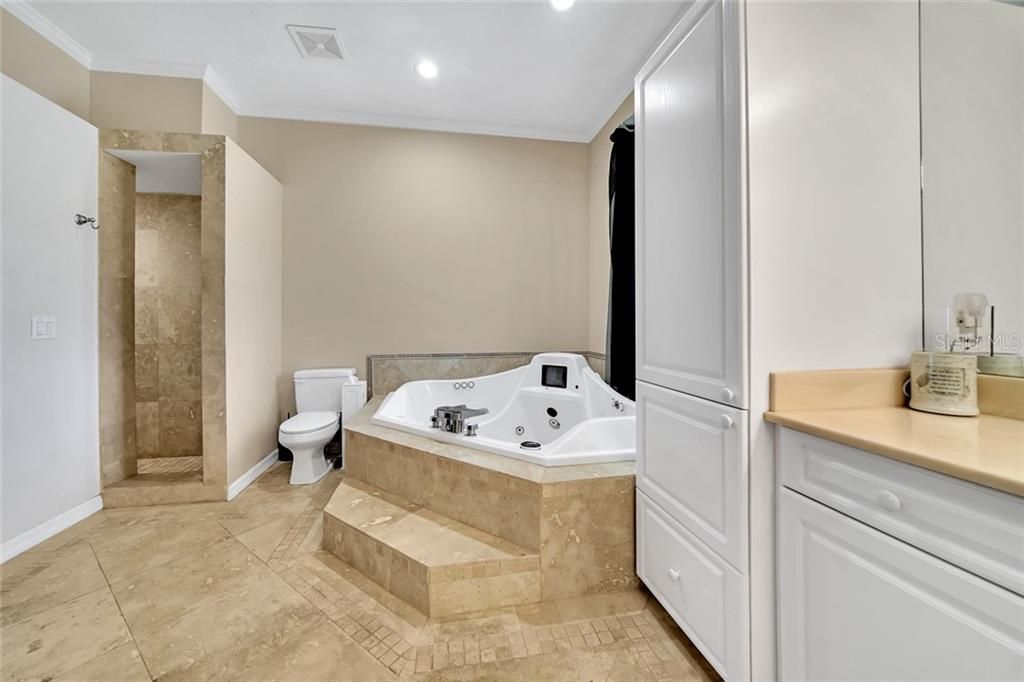 Master bathroom, travertine floors, walk in shower with multiple shower heads