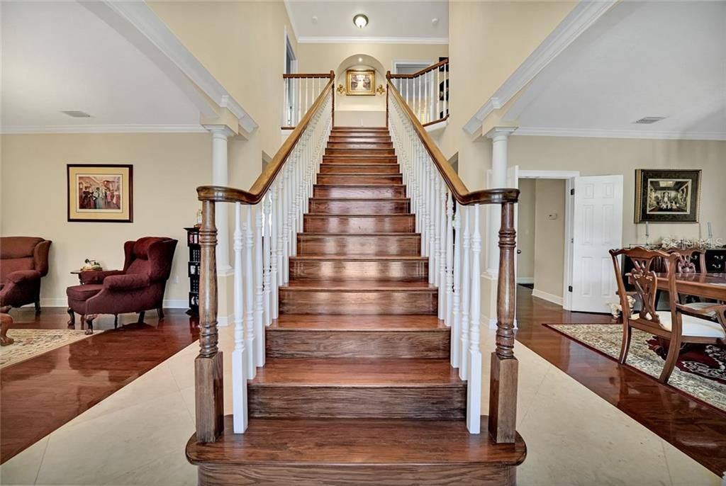 Grand staircase upon entry, marble tile foyer