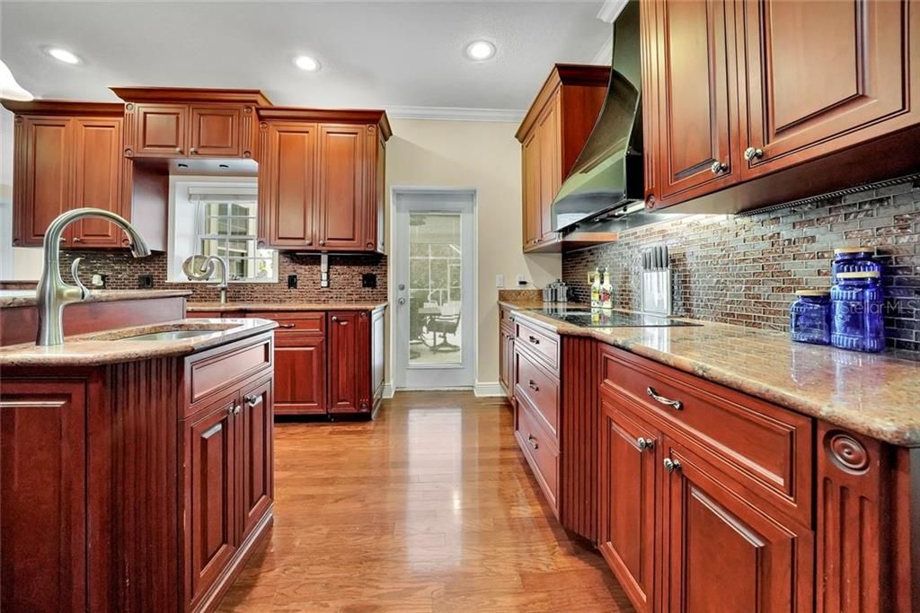 Beautiful granite counter tops, deco backsplash, French door to the Lanai