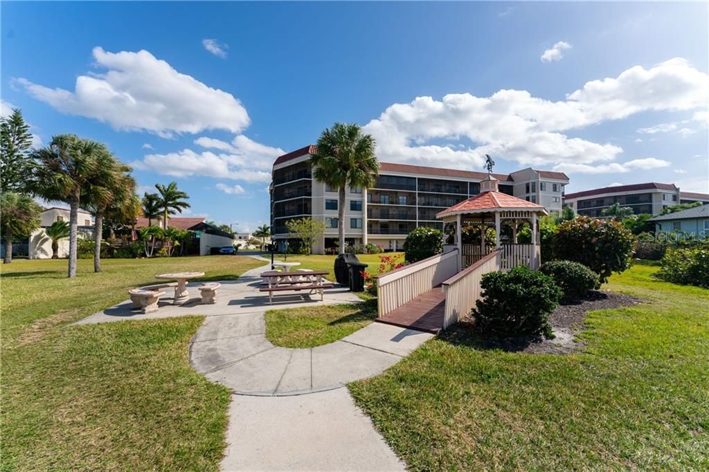 Pergola, tables and grill by the Harbor at Emerald Pointe