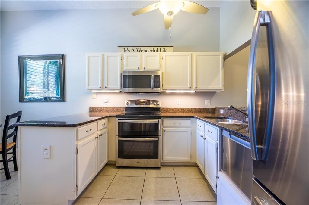 Granite countertops and stainless steel appliances complete this kitchen