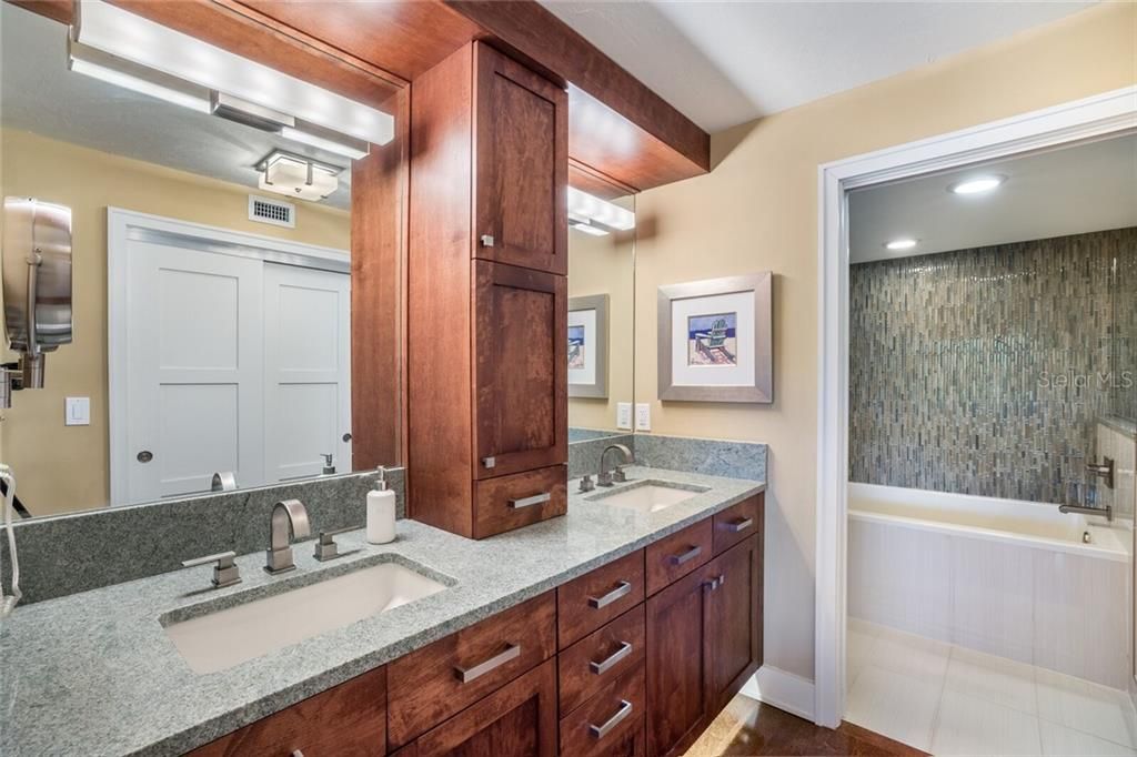 Dual vanities in the master bath with custom lighting, including under-cabinet