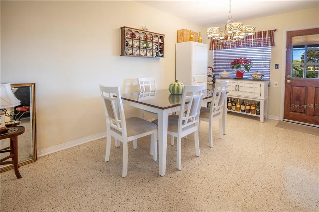 Spacious dining area is open to the kitchen and features access to the screen porch and backyard facing Golf Course