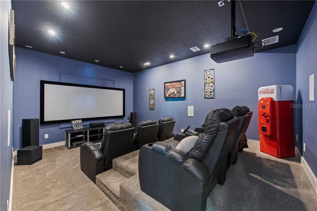 Theater room with elevated seating and plush reclining seating.