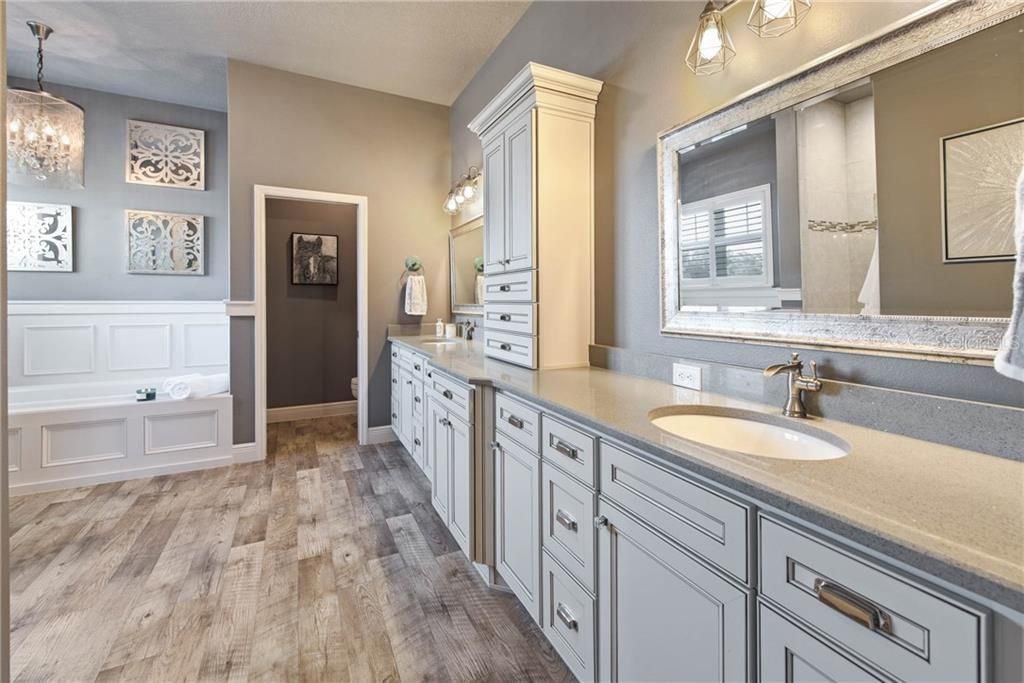 Master bath dual sinks, extra cabinetry tower, soaking tub with gorgeous chandelier, large walk-in shower with heater!