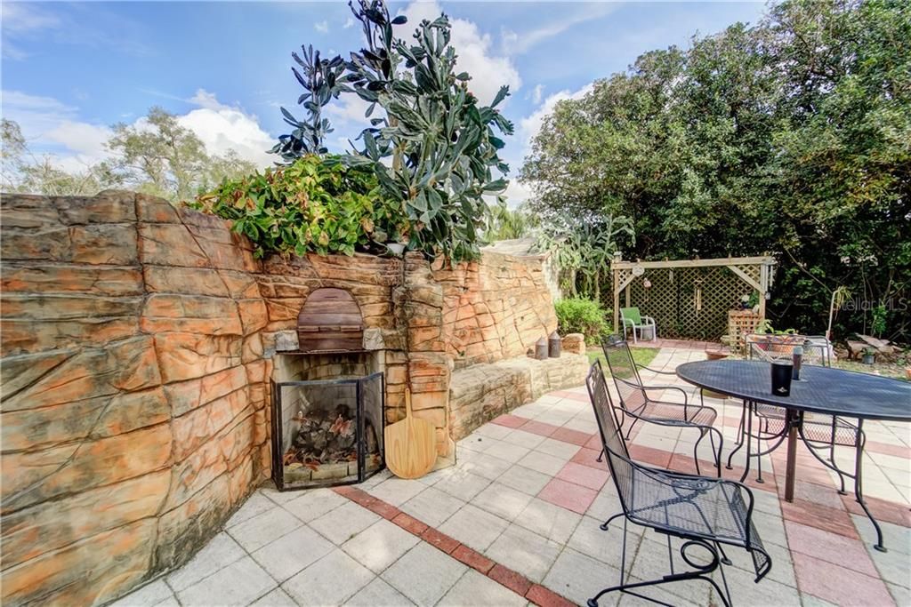 GREAT BACKYARD ENTERTAINMENT AREA INCLUDES FIREPLACE/GRILL COMBO AND PAVED PATIO